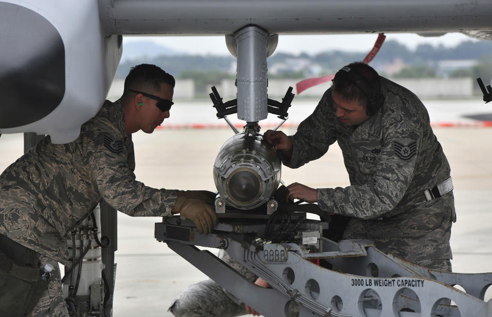 U.S. airmen inspect a bomb loaded onto an A-10 Thunderbolt II close air support aircraft during a demonstration during "Air Power Day" preview at Osan Air Base in Pyeongtaek, South Korea on Sept. 20, 2019.<span class="copyright">Jung Yeon-je—AFP/Getty Images</span>