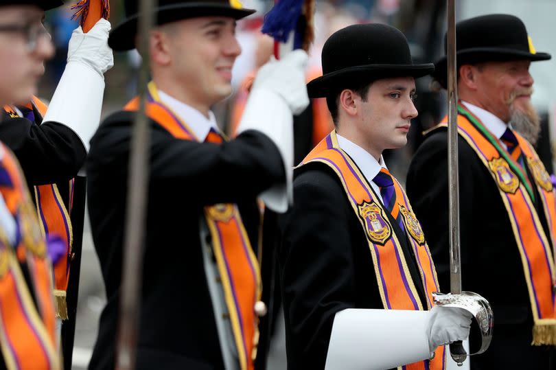 Bandsmen and Orange Order members take part in an Orange Order parade in  Belfast, as part of the annual Twelfth of July celebrations