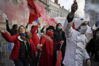 People dance during a demonstration against the closure of the nightclubs, bars, shops and restaurants, in Lyon, central France, Monday, Nov. 23, 2020. France has surpassed 2 million confirmed cases of coronavirus, the fourth-highest total in the world. (AP Photo/Laurent Cipriani)