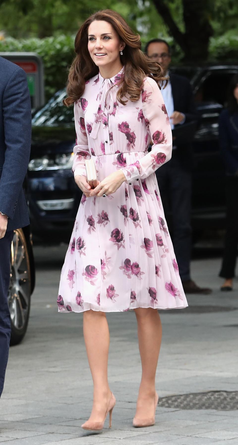 <p>Kate looked pretty in pink in a pleated chiffon dress by American brand Kate Spade. Featuring a delicate rose print, the Duchess accessorised with her usual nude bag and shoes. <i>[Photo: Getty]</i> </p>