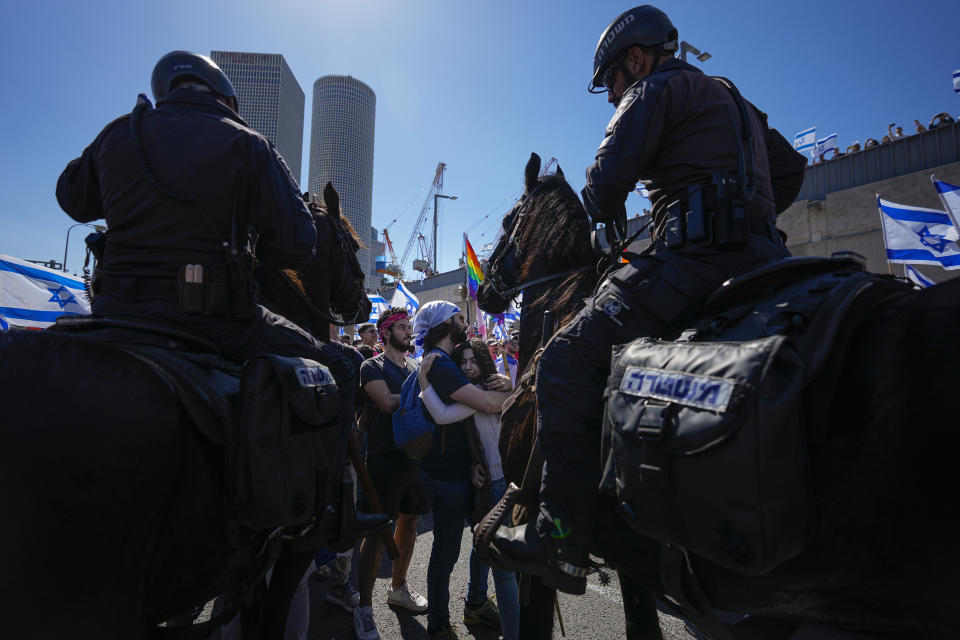 Israelis huge as they protest against plans by Prime Minister Benjamin Netanyahu's new government to overhaul the judicial system while Israeli mounted policemen block their way on the main freeway in Tel Aviv, Israel, Thursday, March 16, 2023. (AP Photo/Ohad Zwigenberg)