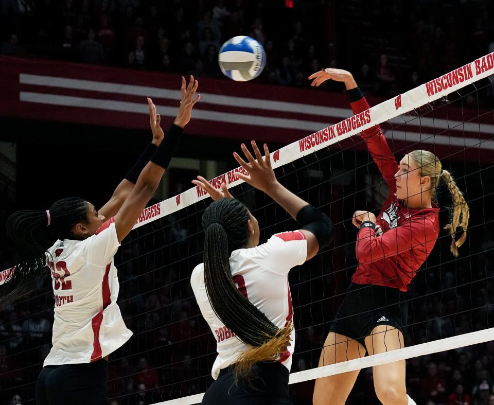 Middle blocker Carter Booth, left, has helped the Badgers lead the nation with 3.09 blocks per set.