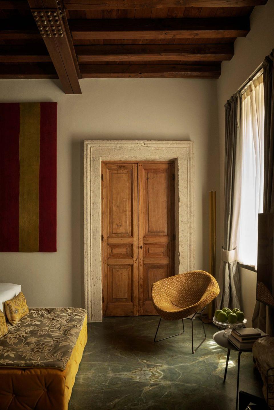 a room with a wood door and a chair