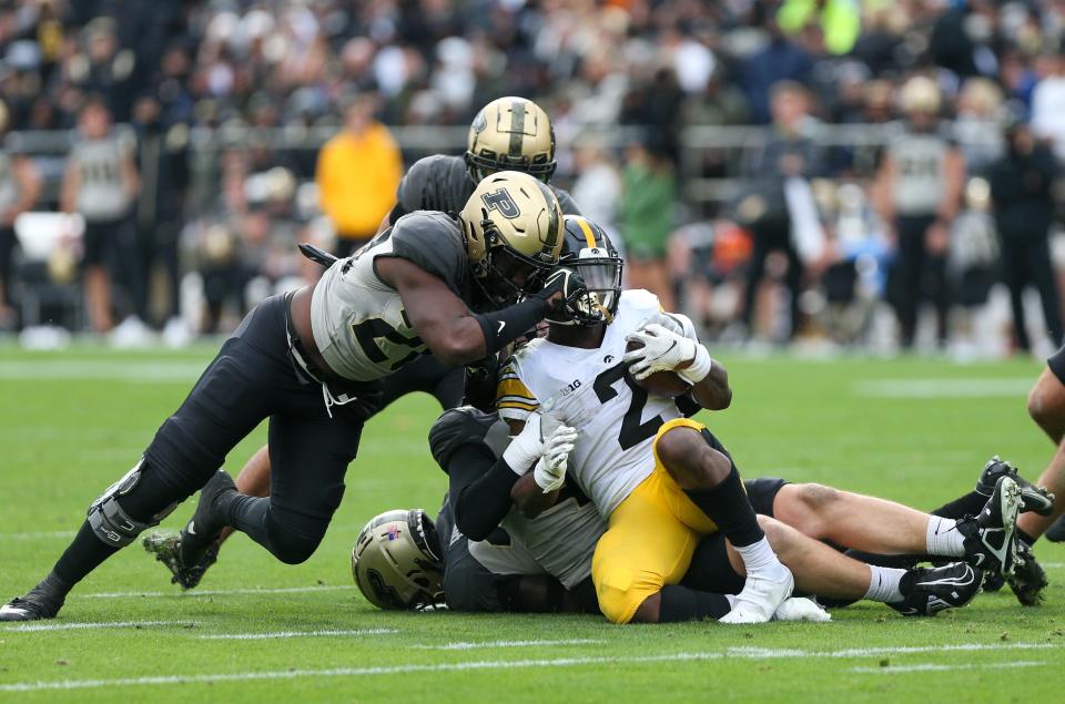 Purdue Boilermakers defensive line tackles Iowa Hawkeyes running back Kaleb Johnson (2) during the NCAA football game, Saturday, Nov. 5, 2022, at Ross-Ade Stadium in West Lafayette, Ind.