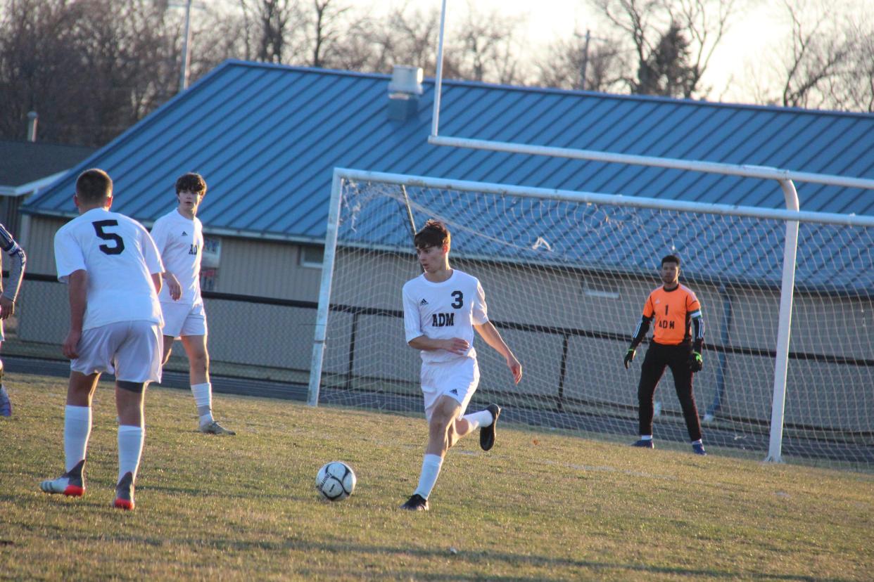 ADM's Tom Hook drives with the ball on Monday, April 4, 2022, in Perry.