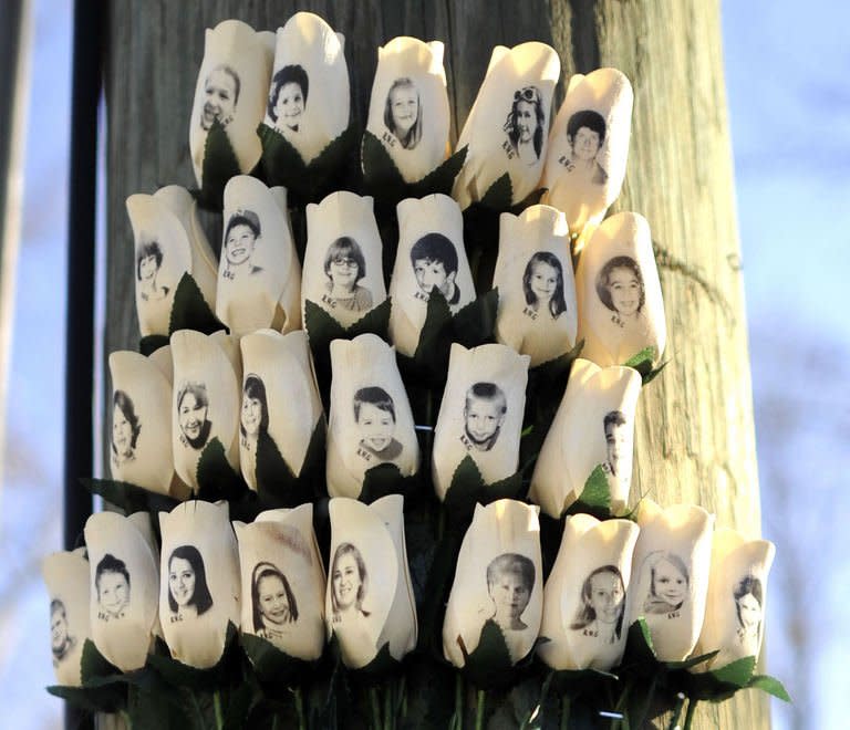 Roses with the faces of the Sandy Hook Elementary students and adults killed are seen on a pole in Newtown, Connecticut on January 3, 2013. Students at the elementary school where a gunman massacred 26 children and teachers last month were returning Thursday to classes at an alternative campus described by police as "the safest school in America."