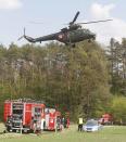 A armed forces’ patrolling helicopter flies over the site where an illegal chopper crashed in a security exercise scenario in Jasce, Poland on Wednesday, April 23, 2014. The three-day exercise is to test the response of internal security services to emergency situations and is held at a time of conflict between Poland’s two neighbors, Ukraine and Russia. (AP Photo/Czarek Sokolowski)