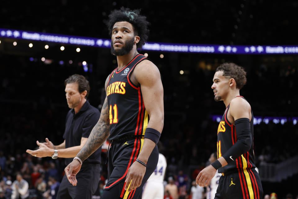 Atlanta Hawks head coach Quin Snyder, left, forward Saddiq Bey, center, and guard Trae Young, right, leave the court after an NBA basketball game against the Philadelphia 76ers, Friday, April 7, 2023, in Atlanta. (AP Photo/Alex Slitz)