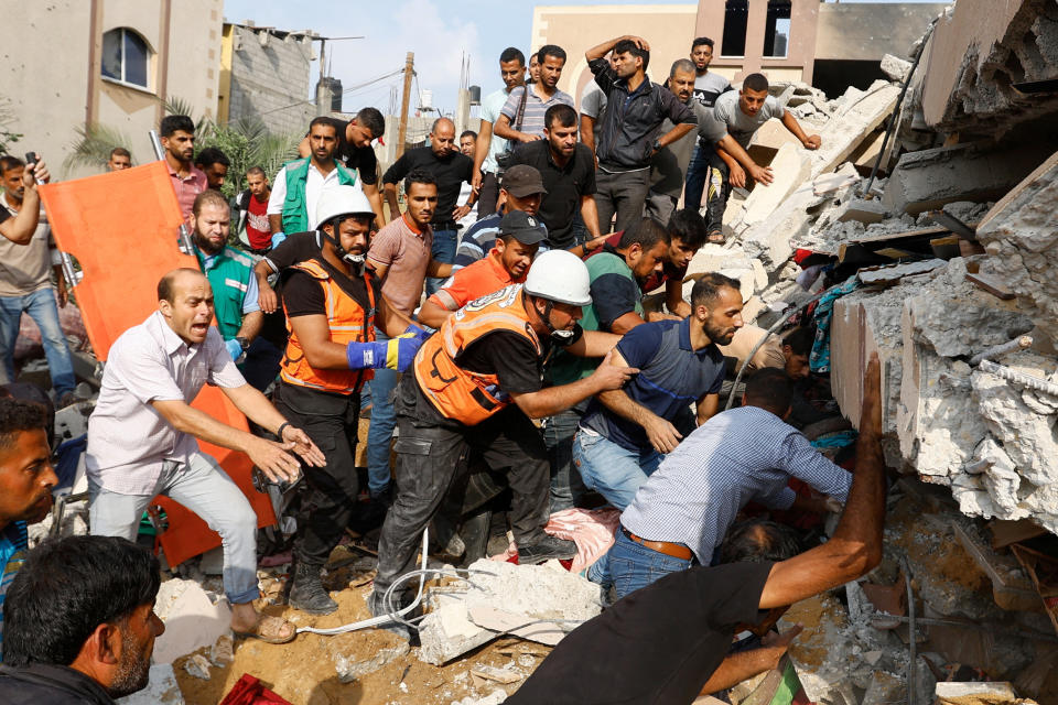 Palestinians search for survivors in the rubble of a house in the southern Gaza Strip on Sunday. (Ibraheem Abu Mustafa/Reuters)