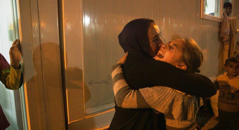 The moment a young girl who was abducted by ISIS is reunited with her family in a camp for displaced people in northern Iraq.