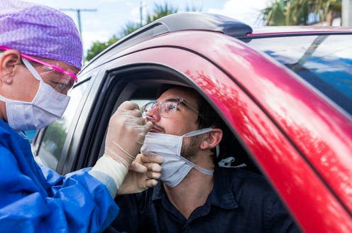 <span class="caption">Some parts of the world have started drive-thru swab tests. </span> <span class="attribution"><a class="link " href="https://www.shutterstock.com/image-photo/doctor-protective-suit-taking-nasal-swab-1687321885" rel="nofollow noopener" target="_blank" data-ylk="slk:zstock/ Shutterstock;elm:context_link;itc:0;sec:content-canvas">zstock/ Shutterstock</a></span>