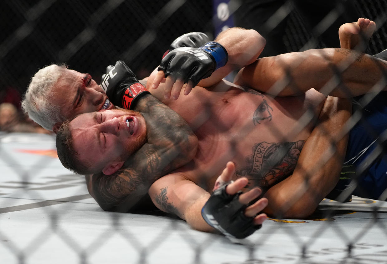 PHOENIX, ARIZONA - MAY 07: (L-R) Charles Oliveira of Brazil secures a rear choke submission against Justin Gaethje in the UFC lightweight championship fight during the UFC 274 event at Footprint Center on May 07, 2022 in Phoenix, Arizona. (Photo by Jeff Bottari/Zuffa LLC)