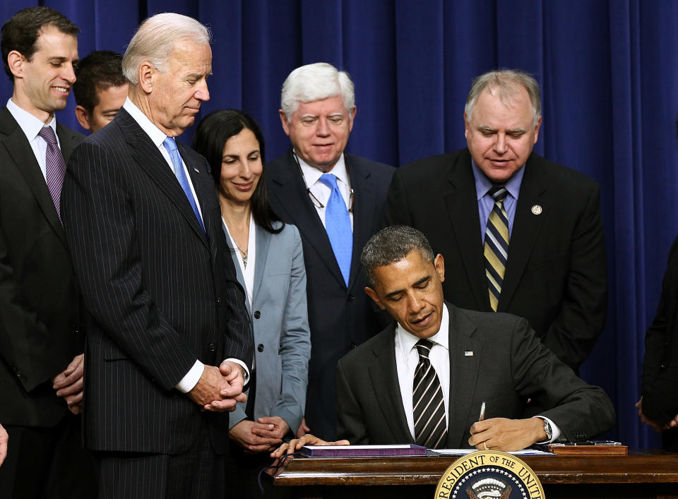 WASHINGTON, DC - APRIL 04:  Surrounded by members of Congress and U.S. Vice President Joe Biden, U.S. President Barack Obama signs the STOCK Act into law at the Eisenhower Executive Office Building April 4, 2012 in Washington, DC. The STOCK Act is a bipartisan bill that prevents members of Congress from trading stocks based on nonpublic information they gleaned on Capitol Hill.  (Photo by Win McNamee/Getty Images)