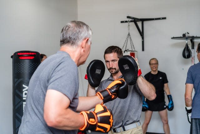 Paul Hebbler works out with those in the Rock Steady Boxing program.