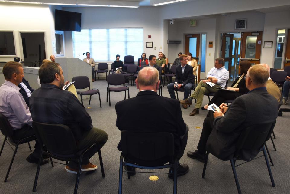 Congressman Derek Kilmer, EPA Region 10 Administrator Casey Sixkiller, Port Orchard mayor Rob Putaansuu, and other local officials and community leaders discuss the City of Port Orchard's plan to redevelop downtown Port Orchard in the Port Orchard City Hall on June 26.