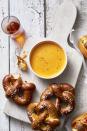 <p>Is there anything better than warm, soft pretzels paired perfectly with a flavorful cheese dip?</p><p>Get the <a href="https://www.goodhousekeeping.com/food-recipes/party-ideas/a46047/creamy-beer-cheese-recipe/" rel="nofollow noopener" target="_blank" data-ylk="slk:Creamy Beer Cheese recipe;elm:context_link;itc:0;sec:content-canvas" class="link "><strong>Creamy Beer Cheese recipe</strong></a>. </p>