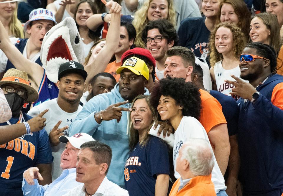Former Auburn and NFL player Takeo Spikes poses with the student section at Auburn Arena in Auburn, Ala., on Wednesday, Feb. 23, 2022. Auburn Tigers defeated Mississippi Rebels 77-64.