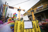 A man wearing a float depicting the partially collapse Hard Rock Hotel has a sign that notes it as a protest of the lack of oversight of the building and a memorial to those who lost their lives in the St. Anne parade in the Marigny on Mardi Gras Day in New Orleans, La. Tuesday, Feb. 25, 2020./The Advocate via AP)