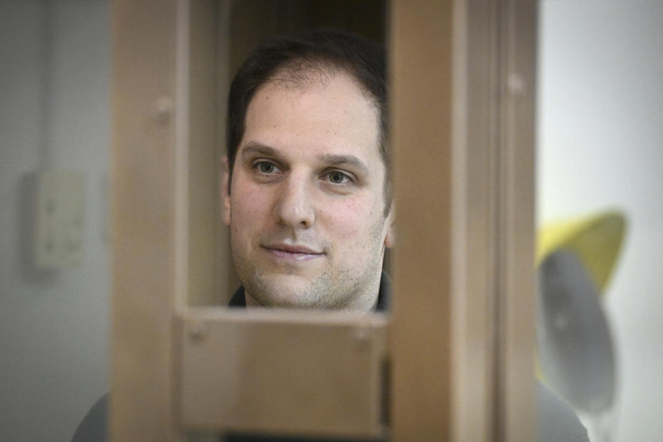 Wall Street Journal reporter Evan Gershkovich stands in a glass cage in a courtroom at the Moscow City Court, in Moscow, Russia, on Thursday, Dec. 14, 2023. Wall Street Journal reporter Evan Gerhskovich, arrested in Russia on espionage charges, will remain in detention until Jan. 30, a court in Moscow ruled on Thursday. The hearing took place behind closed doors because authorities say details of the criminal case against the American journalist are classified. (AP Photo/Dmitry Serebryakov)