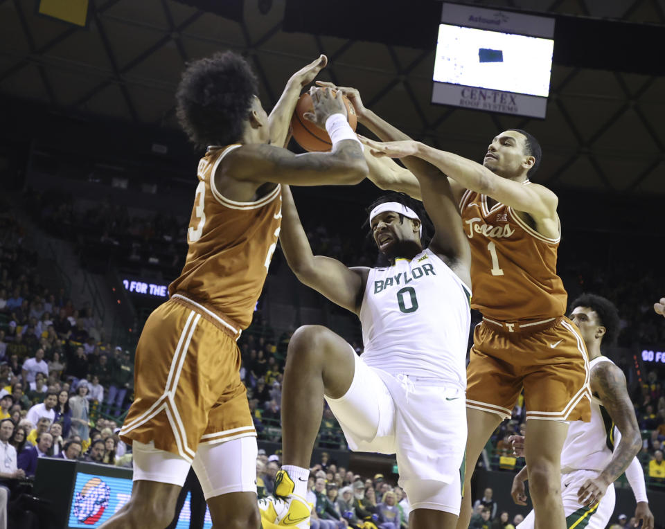 Baylor forward Flo Thamba (0) is pressured by Texas forward Dillon Mitchell (23) and forward Dylan Disu (1) in the first half of an NCAA college basketball game, Saturday, Feb. 25, 2023, in Waco, Texas. (Rod Aydelotte/Waco Tribune-Herald via AP)