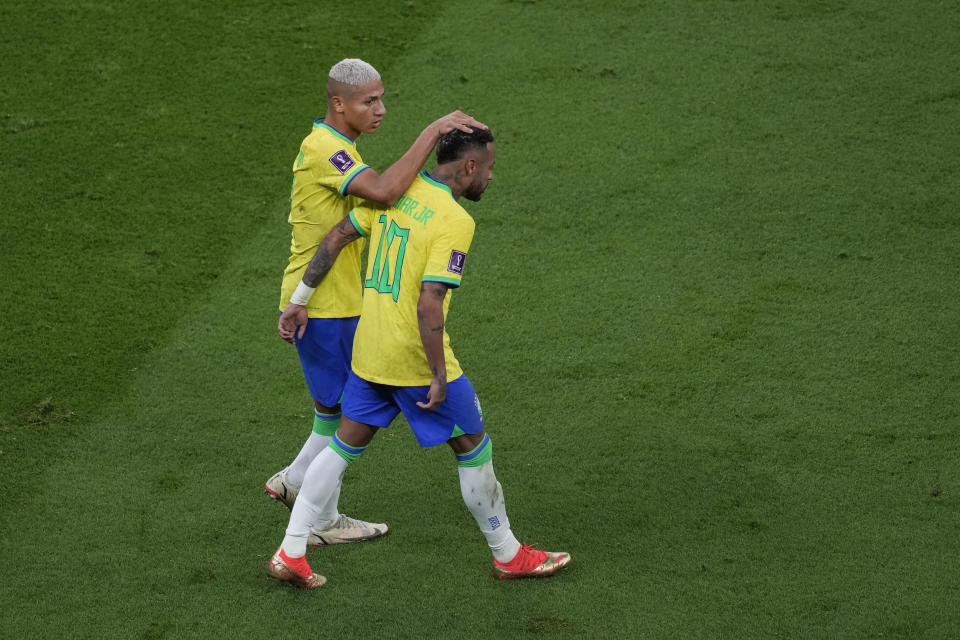 Brazil's Richarlison, left, celebrates the opening goal of his team with his teammate Neymar during the World Cup group G soccer match between Brazil and Serbia, at the the Lusail Stadium in Lusail, Qatar on Thursday, Nov. 24, 2022. (AP Photo/Darko Vojinovic)
