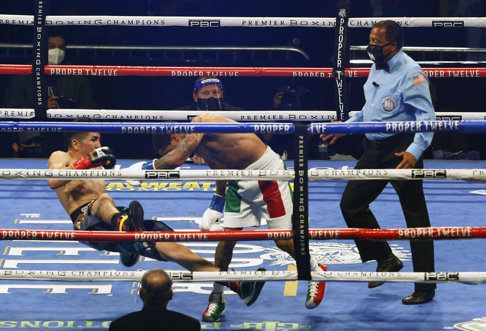 Gervonta Davis, right, pushes Leo Santa Cruz down during a boxing bout Saturday, Oct. 31, 2020, in San Antonio. (AP Photo/Ronald Cortes)