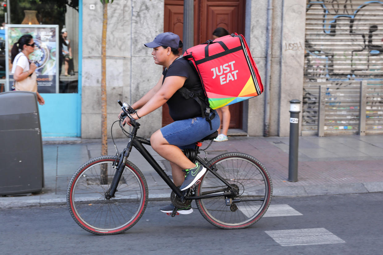 A distributor of Just Eat rides his bike with a package with food on a street on July 31, 2019 in Madrid, Spain. Photo: JesÃºs HellÃ­n/Europa Press via Getty Images