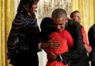 U.S. President Barack Obama hugs 2016 Olympic individual all-around gymnast Simone Arianne Biles as he welcomes U.S. Olympic and Paralympics teams at the White House in Washington, U.S., September 29, 2016. REUTERS/Yuri Gripas