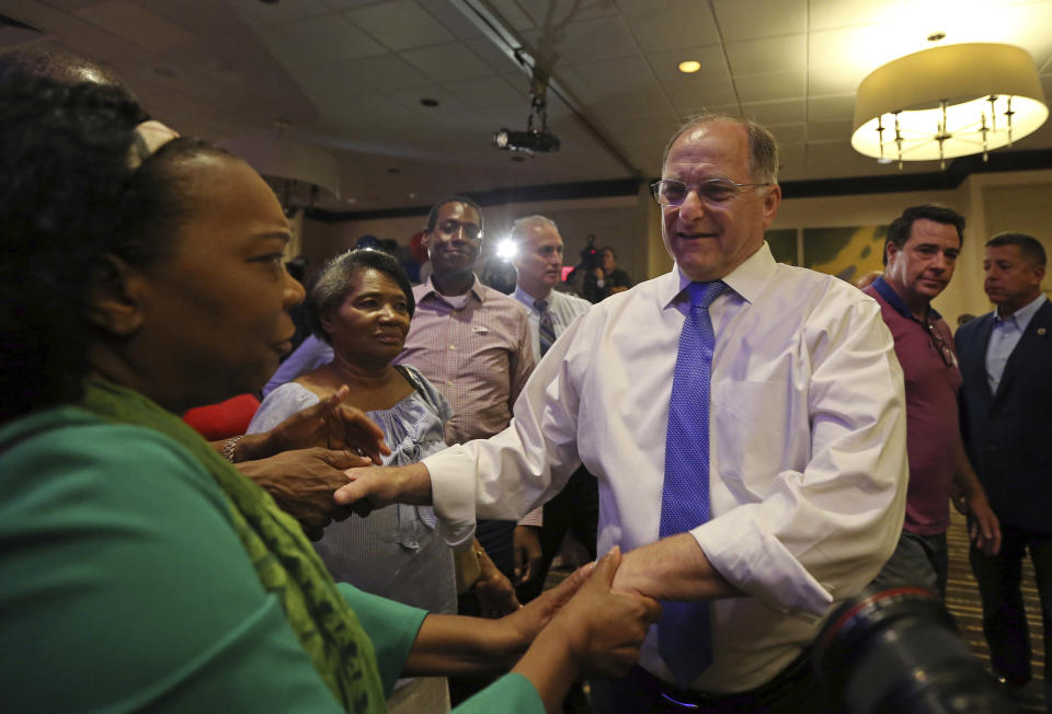 Rep. Michael Capuano greets supporters after conceding defeat to Boston City Councilor Ayanna Pressley in the 7th Congressional House Democratic primary, Tuesday, Sept. 4, 2018, at his primary night party in Somerville, Mass. (AP Photo/Elise Amendola)