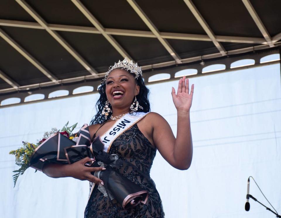 Destiny Bass, of Pierce County, smiles and waves to her family after being crowned the 2024 Miss Juneteenth during the Juneteenth Celebration held in Stewart Heights Park on Wednesday, June 19, 2024, in Tacoma.