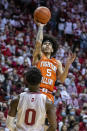 Illinois guard Andre Curbelo (5) shoots over Indiana guard Xavier Johnson (0) during the first half of an NCAA college basketball game, Saturday, Feb. 5, 2022, in Bloomington, Ind. (AP Photo/Doug McSchooler)