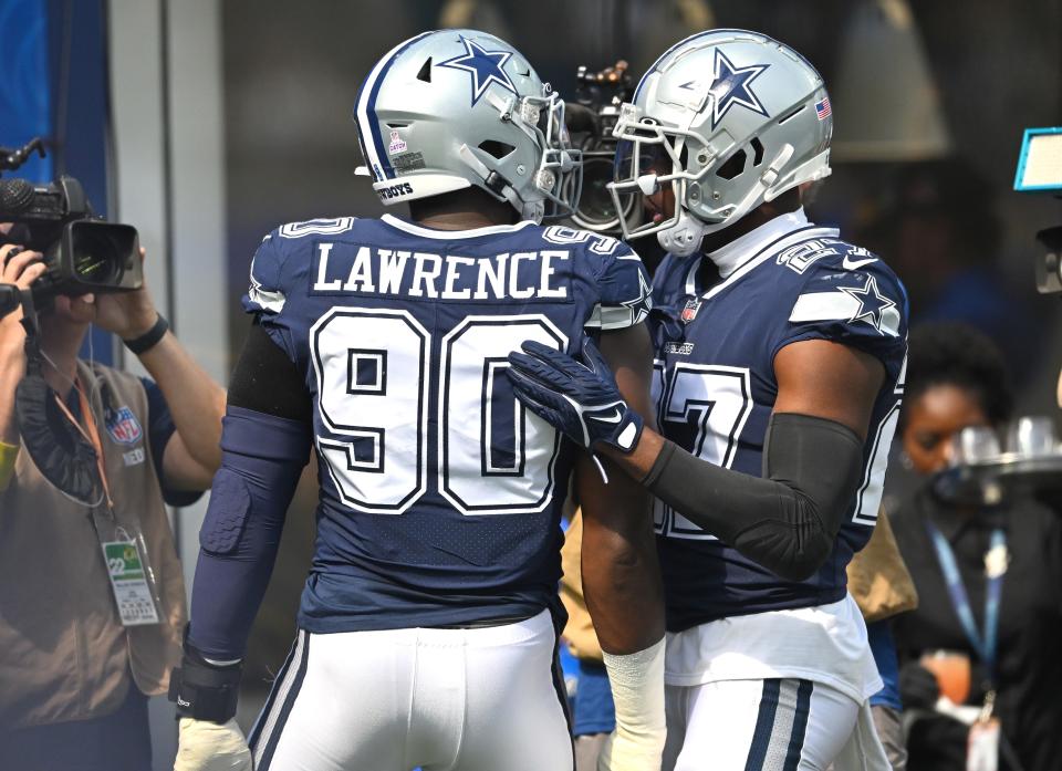 Dallas Cowboys defensive end DeMarcus Lawrence (90) celebrates after scoring a touchdown after recovering a fumble in the first quarter against the Los Angeles Rams.