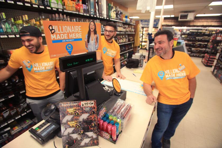 Frazier Park, CA - May 26: Chris Khalil, Johnny Khalil and his father Nidal Khalil share a lite moment prior to celebrations and press conference after a 1.7 billion dollar lottery ticket was sold at his Midway Market & Liquour in Frazier Mountain on Thursday. On Wednesday night, 54-year-old Nidal Khalil's phone kept buzzing with congratulations from friends and family. His family in Syria were also alerted over Facebook about the news. Thursday, October 12, 2023 in Frazier Park, CA. (Alex Horvath / Los Angeles Times)