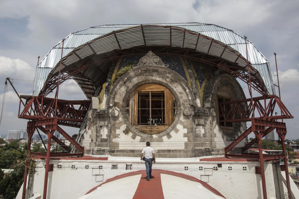 Parishioner Carlos Jimenez Taboada walks on the exterior of the central nave towards the quake-damaged dome of the Our Lady of the Angels Catholic church in Mexico City, Mexico, Sunday, Aug. 7, 2022. Set in the working-class residential neighborhood of Guerrero and carrying one of the Virgin Mary's titles, Our Lady of the Angels’ history dates to the end of the 16th century. (AP Photo/Ginnette Riquelme)