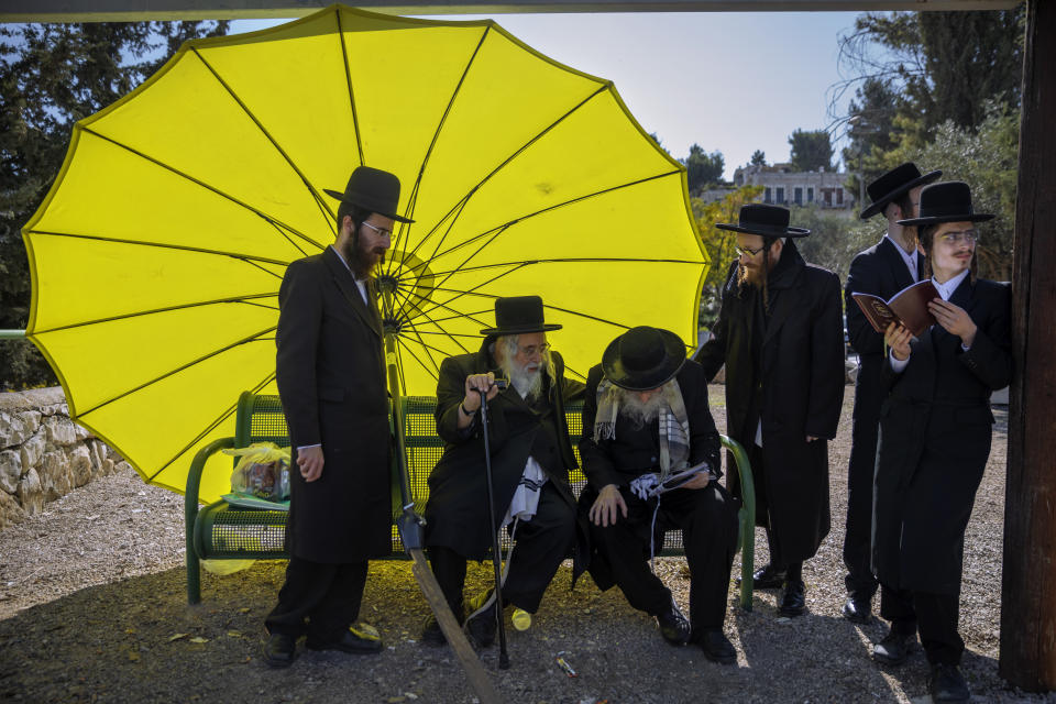 Ultra-Orthodox Jewish men gather for a protest against the construction of a hotel at a site that protesters claim contains ancient graves, in Jerusalem, Wednesday, Nov. 18, 2020. (AP Photo/Oded Balilty)