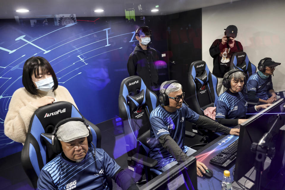 Sixty five-year-old esport player Chiang Yi-Shu, second from right and her teammates all above 60 years old take part in a competition at the Hungkuang University in Taichung, Taiwan on Saturday, Dec. 17, 2022. Chiang is one of the League of Legends players on Hungkung Evergreen Gaming's team, established this summer. The team, whose members range from 62 to 69 years old, was founded by Huang Jianji, the director of the department of Multimedia Game development and application of Hungkuang University. They competed in their first-ever video game tournament Saturday at the university. (AP Photo/I-Hwa Cheng)