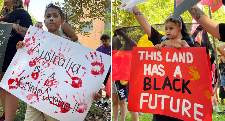 A child holds a poster reading 'Australia is a crime scene' at an Australia Day protest in Sydney.