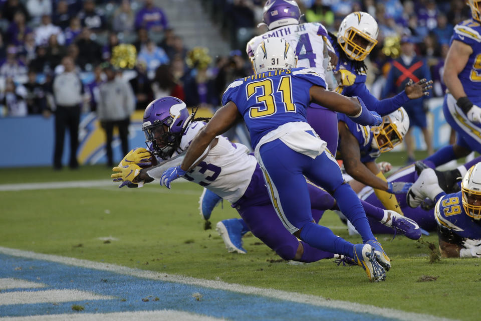 Minnesota Vikings running back Mike Boone scores a touchdown during the second half of an NFL football game against the Los Angeles Chargers,. Sunday, Dec. 15, 2019, in Carson, Calif. (AP Photo/Marcio Jose Sanchez)
