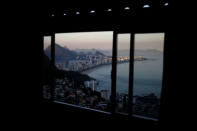 Ipanema beach is seen through a window at the Alto Vidigal hostel in Vidigal favela, in Rio de Janeiro, Brazil, April 23, 2016. REUTERS/Pilar Olivares