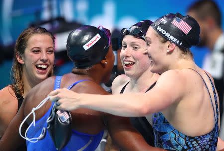 Swimming – 17th FINA World Aquatics Championships – Women's 4x100m Medley Relay Final – Budapest, Hungary – July 30, 2017 – Kathleen Baker, Lilly King, Kelsi Worrell and Simone Manuel of the U.S. react after winning the race. REUTERS/Michael Dalder