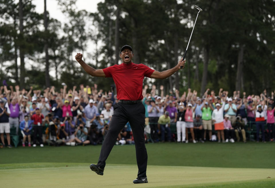 FILE - In this April 14, 2019, file photo, Tiger Woods reacts as he wins the Masters golf tournament in Augusta, Ga. Augusta National decided Friday, March 13, 2020, to postpone the Masters because of the spread of the coronavirus. Club chairman Fred Ridley says he hopes postponing the event puts Augusta National in the best position to host the Masters and its other two events at some later date. Ridley did not say when it would be held. (AP Photo/David J. Phillip, File)