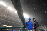 New York Mets manager Buck Showalter, left, and umpire Mark Carlson talk as a rain delay is declared during the ninth inning of a baseball game against the Washington Nationals at Nationals Park, Friday, April 8, 2022, in Washington. (AP Photo/Alex Brandon)