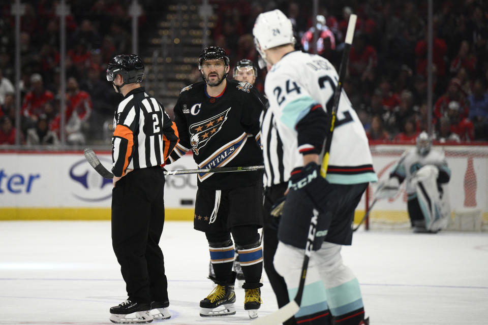 Washington Capitals left wing Alex Ovechkin (8) stares at Seattle Kraken defenseman Jamie Oleksiak (24) after Oleksiak received a match penalty during the second period of an NHL hockey game Friday, Dec. 9, 2022, in Washington. (AP Photo/Nick Wass)