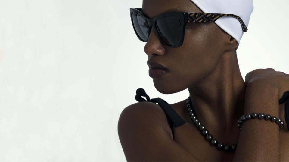 Mikimoto Black Pearl Necklace and Bracelet; Karla Colletto Cap and Bathing Suit; Versace Sunglasses