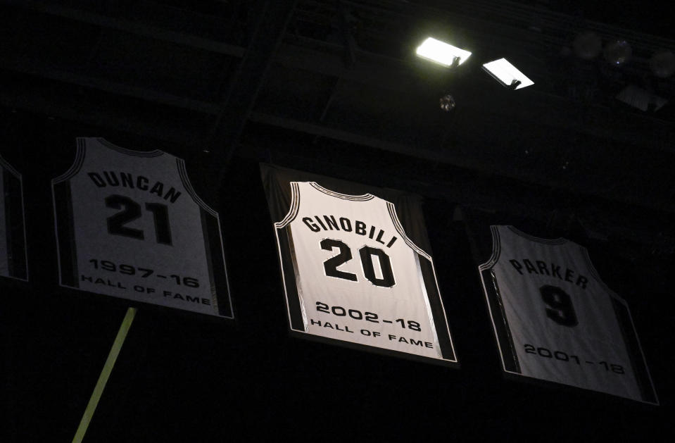 A banner featuring former San Antonio Spurs player and recent Basketball Hall of Fame inductee Manu Ginobili's jersey number is revealed in the during halftime of the Spurs' NBA basketball game against the Charlotte Hornets, Wednesday, Oct. 19, 2022, in San Antonio. (AP Photo/Darren Abate)