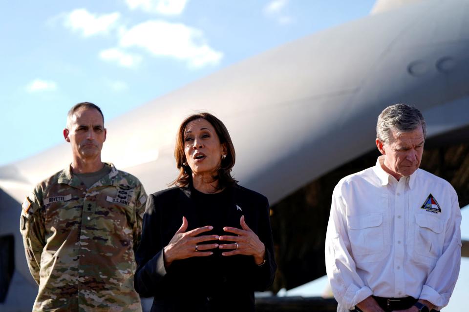 Vice President Kamala Harris, the  Democratic presidential nominee, flanked by North Carolina Gov. Roy Cooper, speaks to the members of the media following a briefing with officials in Charlotte on Saturday.