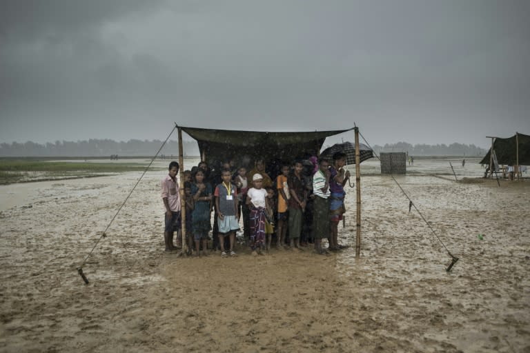 Rohingya Muslim refugees take shelter from the rain at a camp in Bangladesh