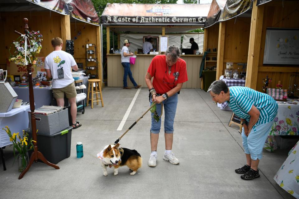 Helena Massey keeps an eye on Rowdy while visiting the booths at Schulz BrÃ¤u Brewing Company's 2nd Annual Maifest Saturday, May 13, 2023. 