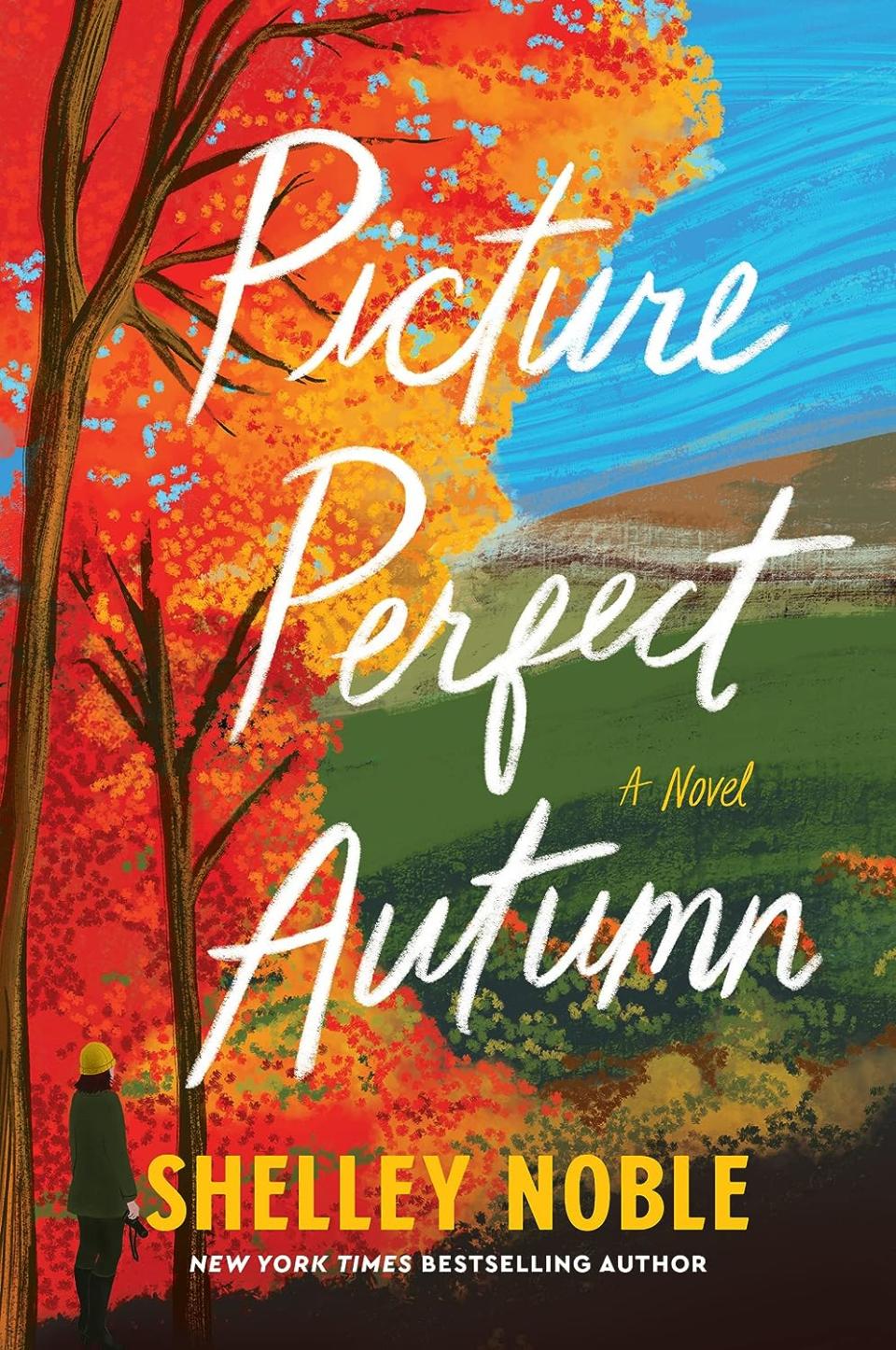 Cozy Fall Reads: Picture Perfect Autumn by Shelley Noble book cover shows the book title in white font over a colorful fall tree set in front of a blue sky