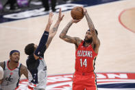 New Orleans Pelicans forward Brandon Ingram (14) shoots against Washington Wizards center Daniel Gafford, center, and guard Bradley Beal (3) during overtime in an NBA basketball game Friday, April 16, 2021, in Washington. (AP Photo/Nick Wass)